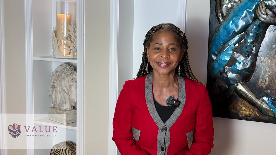 Value Financial Protection welcome video thumbnail. Latonia Chambers-Henry (founder of Value Financial Protection), an African-American woman stands with braided hair, wearing a red blazer, smiling at the camera in a well-lit room with decorative shelves and artwork. A logo in the corner reads “VALUE Financial Protection.”.