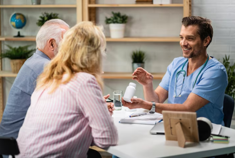 Senior couple discussing Medicare coverage while managing ongoing healthcare needs