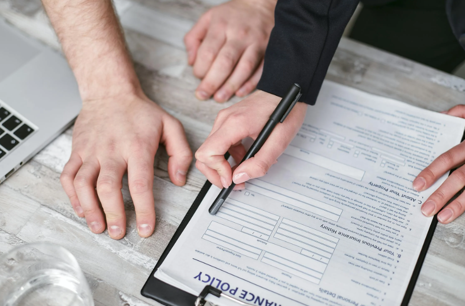 A person signing an insurance policy.