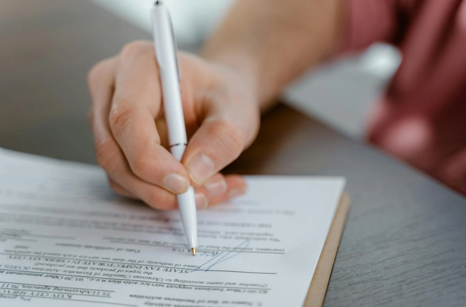 A person signing up for affordable final expense insurance in Georgia.