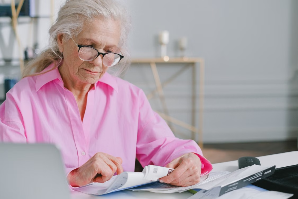 An elderly person looking at documents