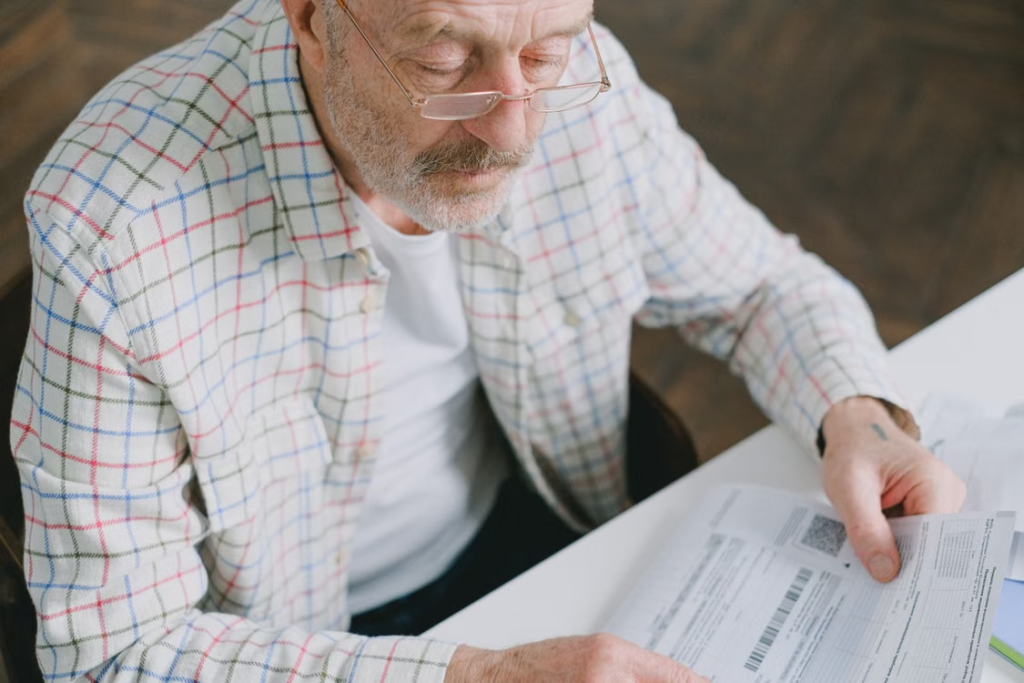 An elderly person checking papers