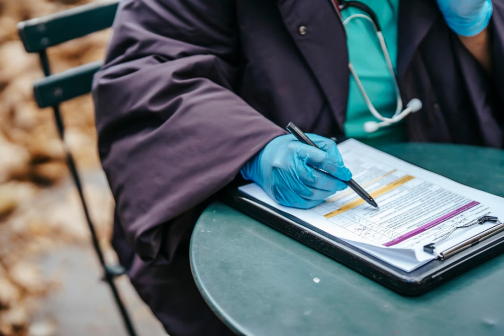A person reviewing a paper attached to a clipboard