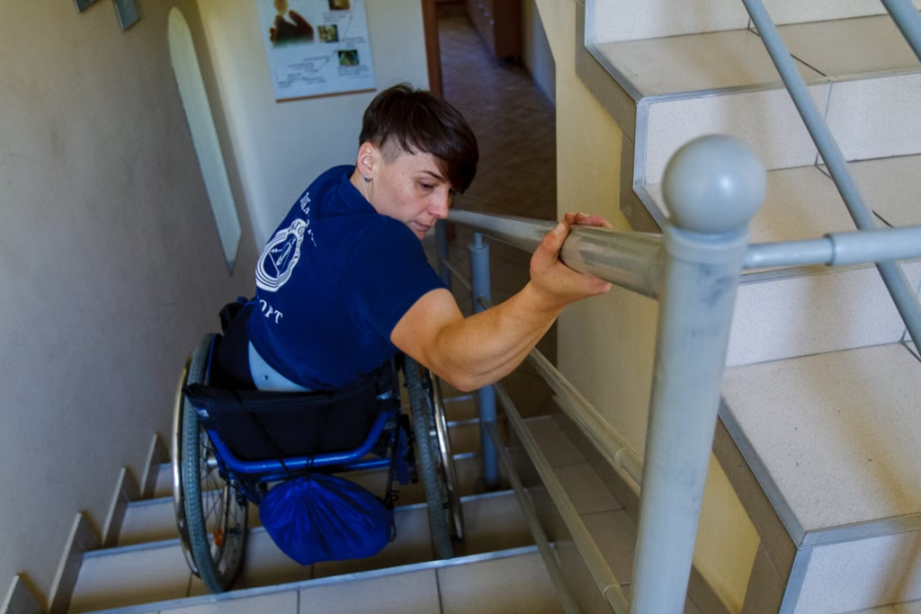 A person in a wheelchair going down the stairs