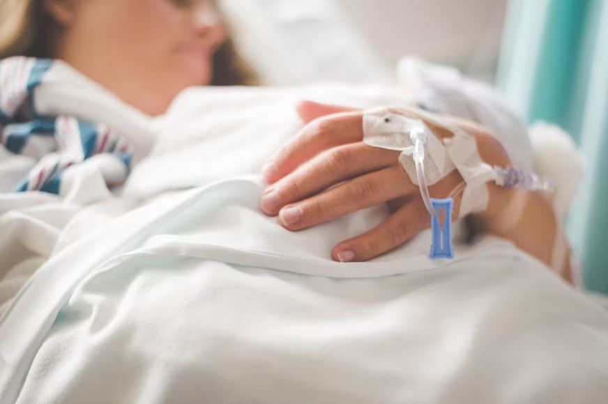 A person with an IV in their hand