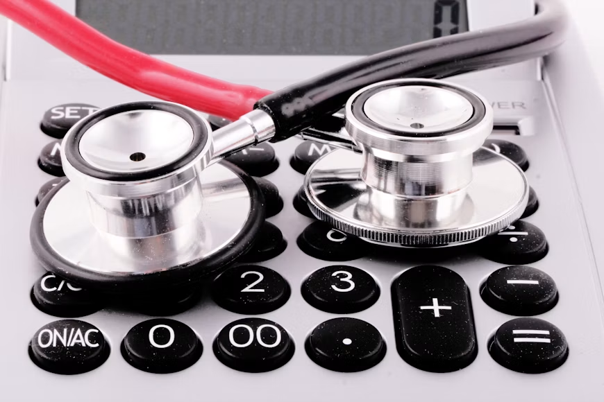 A stethoscope on top of a calculator