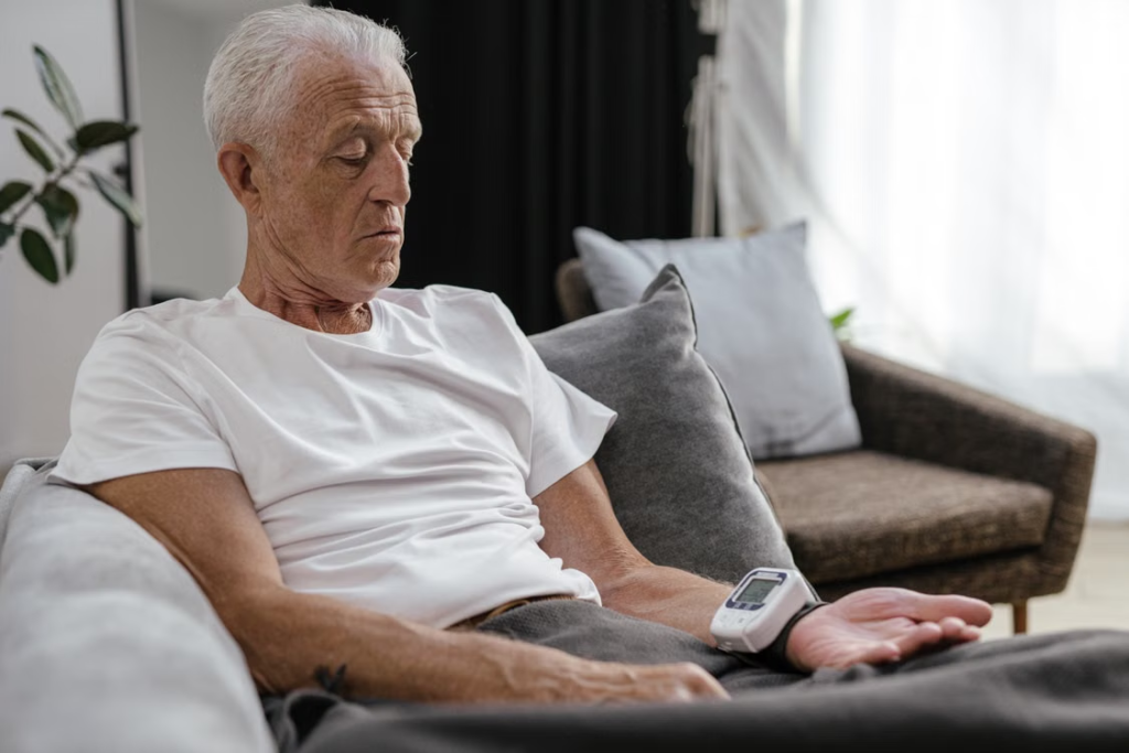 An elderly person checking their blood pressure