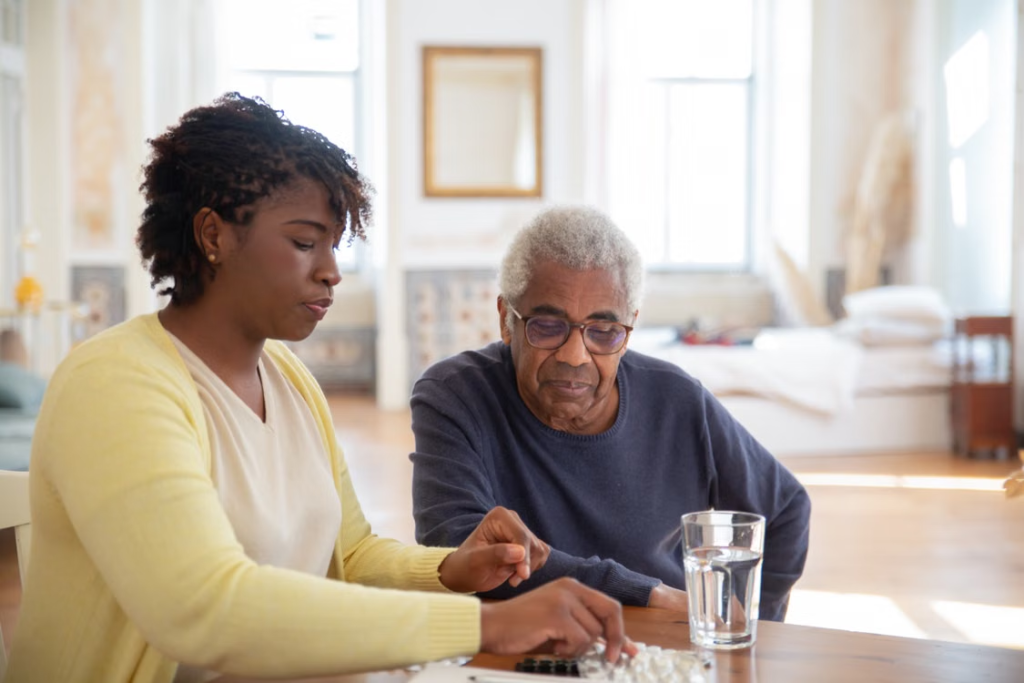 A caregiver explaining the medicine to an elderly person