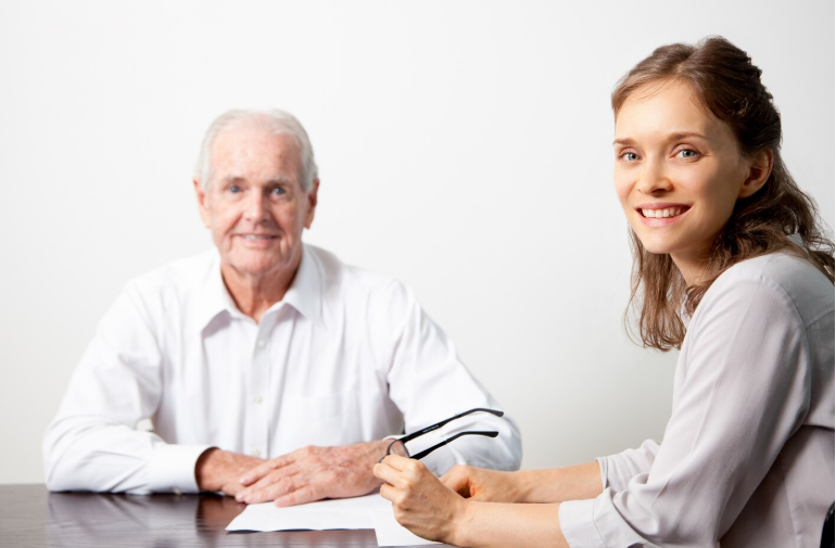 Advisor helping an older couple enroll in Medicare